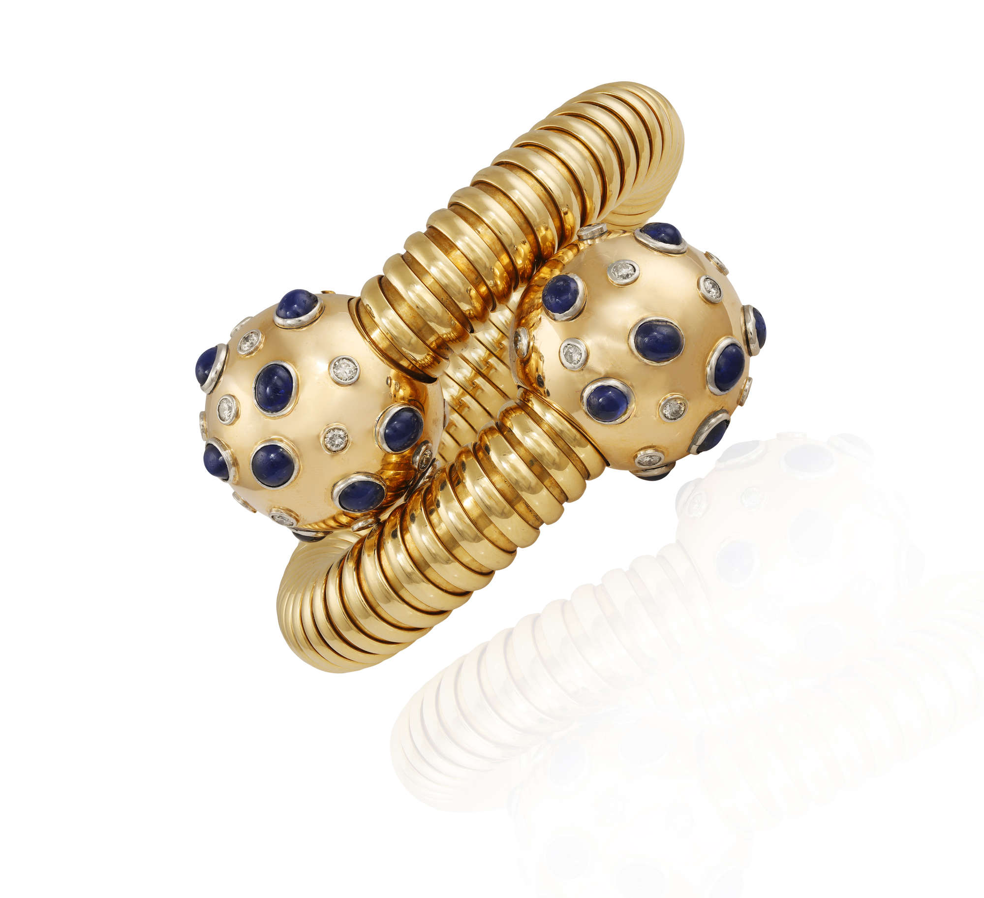 LOT102  THE PRIVATE PROPERTY OF A NOBLE ITALIAN LADY A RARE RETRO  SAPPHIRE AND DIAMOND TUBOGAS BRACELET BY BULGARI CIRCA 1940 The large  coiled gold tubogas bracelet with two spherical terminals